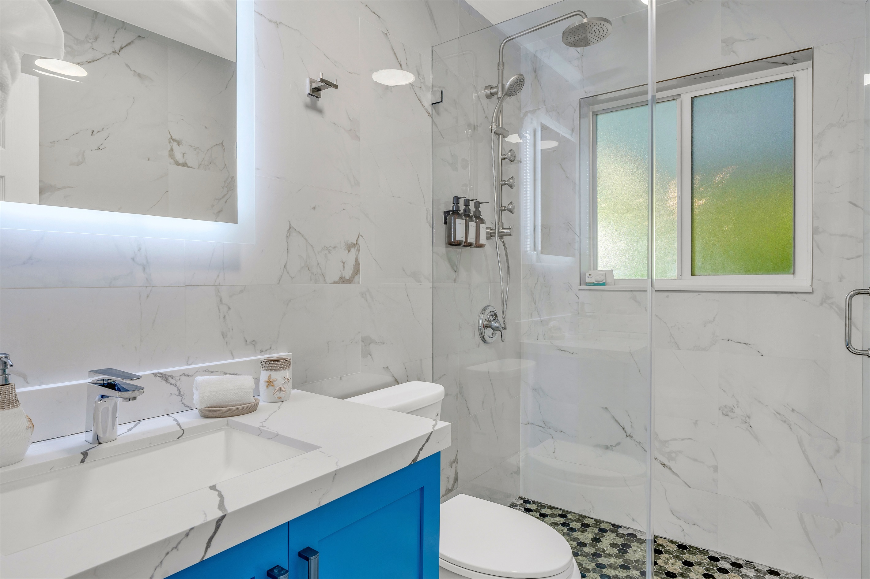 Another bathroom off the hall with jet and rain shower heads.