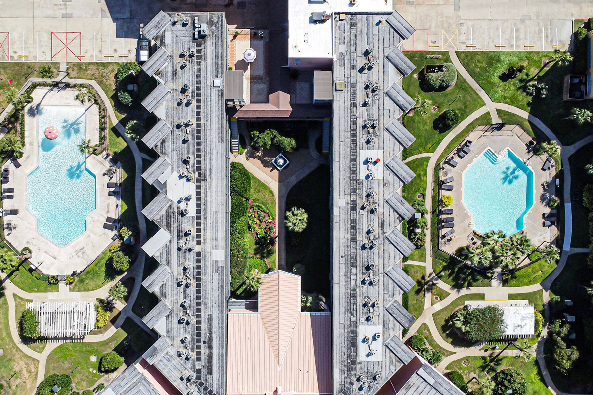 Two large swimming pools (your condo overlooks the one on the right in this picture