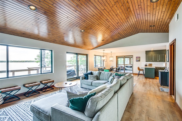 Living room with sliding doors to deck and panoramic lake views