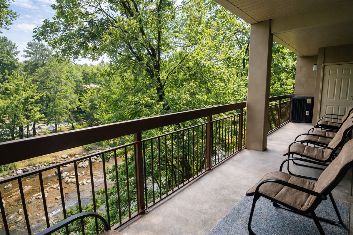 Private balcony over creek with ducks along the riverside.