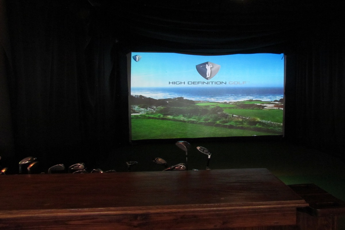 Hone your golf skills or enjoy a virtual round on a world-class course at Village Hideaway's high-definition golf simulator, perfect for both avid golfers and beginners.