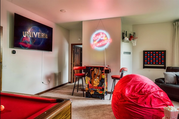 Custom neon sign, pool table, arcade game, 70 inch TV and popcorn bar equals your Private Smoky Mountain Game Room. 