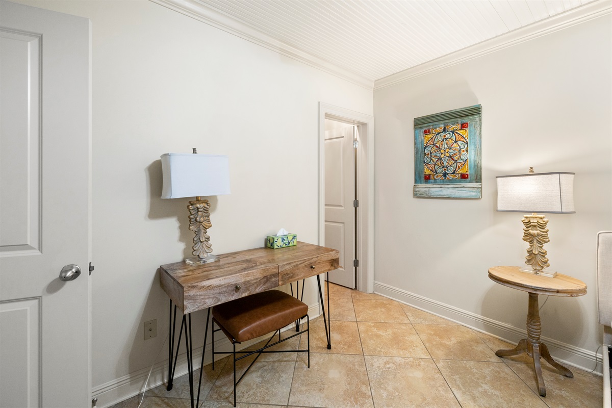 Inviting secondary bedroom with queen bed and desk.