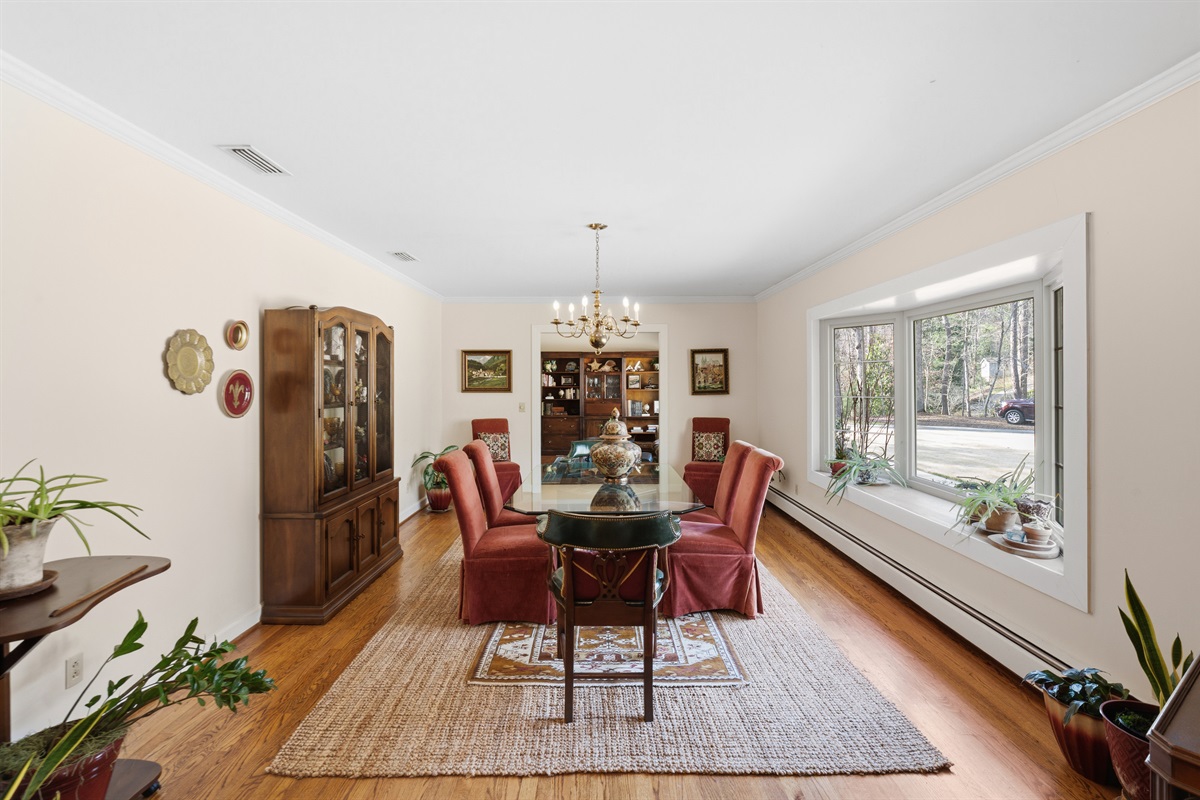 Sunlit dining space with large windows and peaceful outdoor views