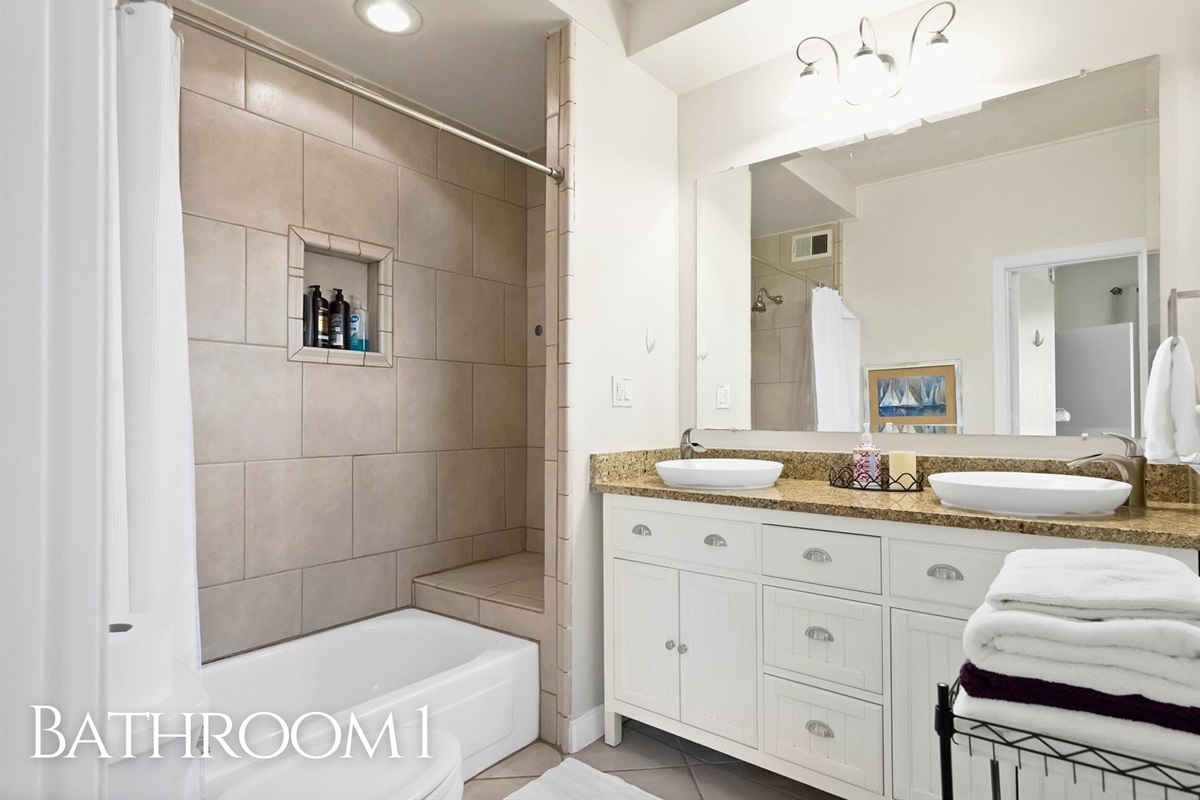 A bright, spacious bathroom with a double vanity and plenty of room to get ready.