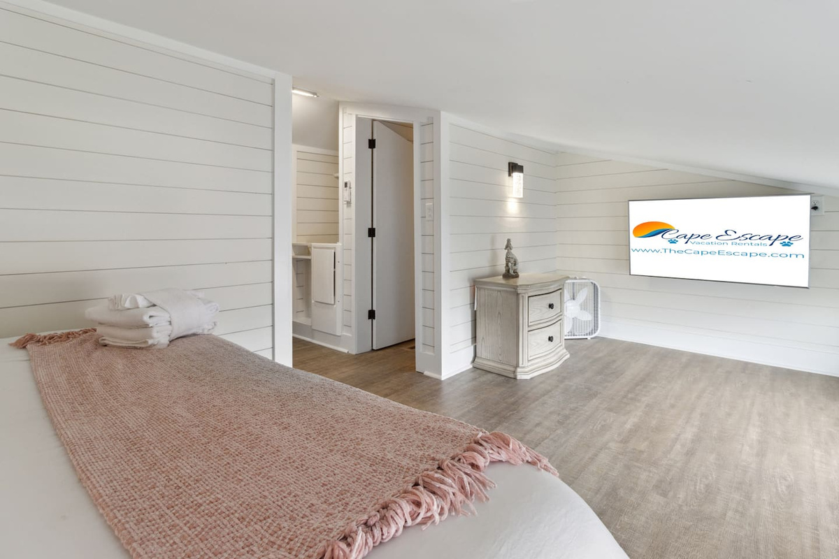 Smart TV, king bed, walk-in shower ensuite &mdash; the loft suite is its own world up there.