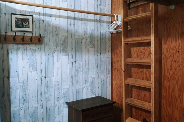 Primary bedroom - hang your clothes here. Ladder for loft against wall.