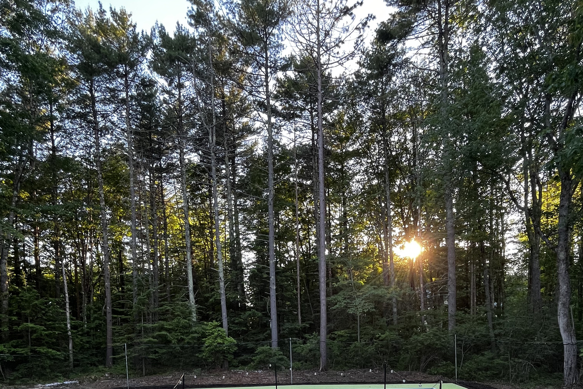 An inviting outdoor firepit surrounded by seating, creating the perfect spot to gather, enjoy drinks, and share stories as the evening winds down.
