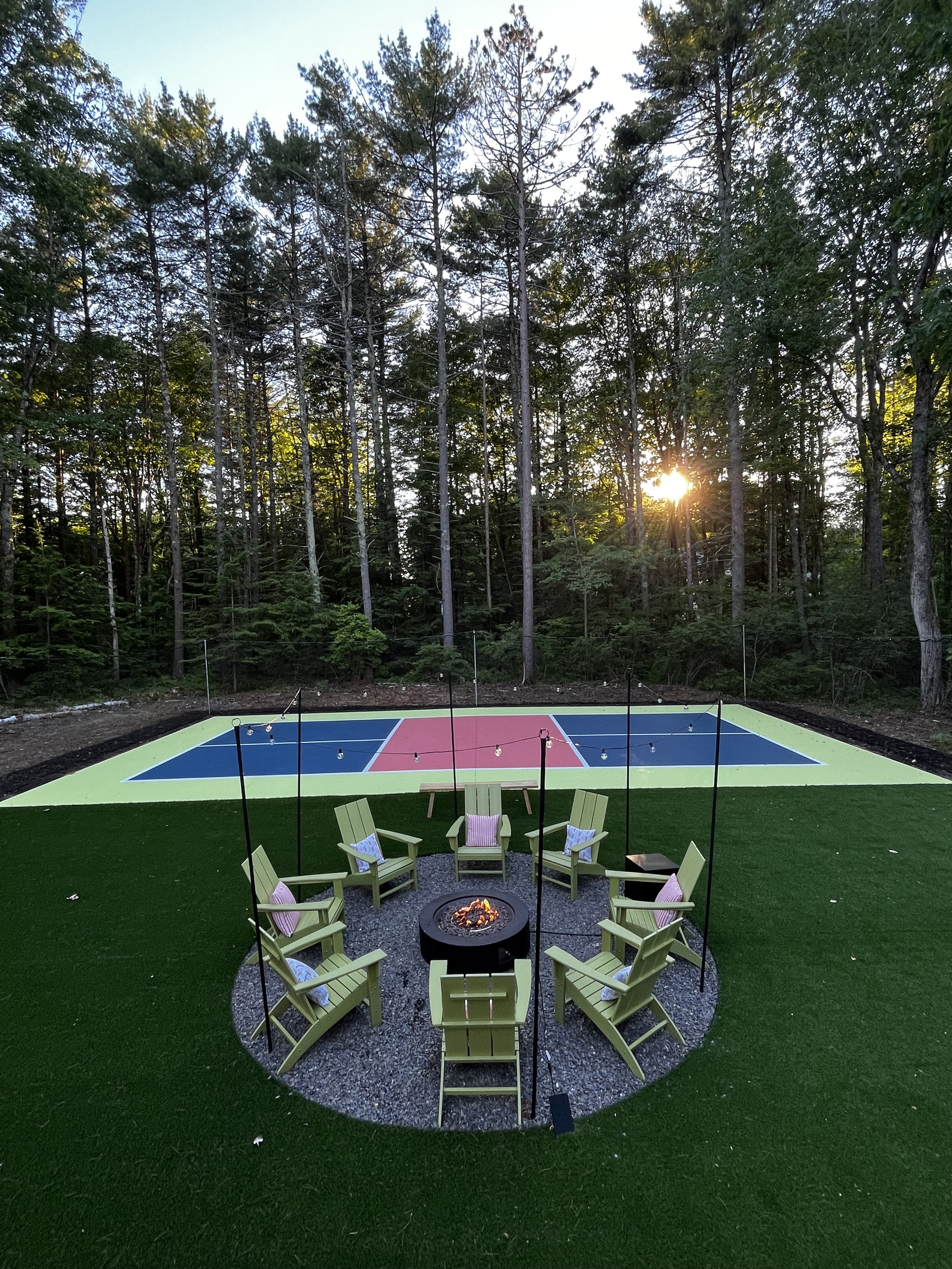 An inviting outdoor firepit surrounded by seating, creating the perfect spot to gather, enjoy drinks, and share stories as the evening winds down.