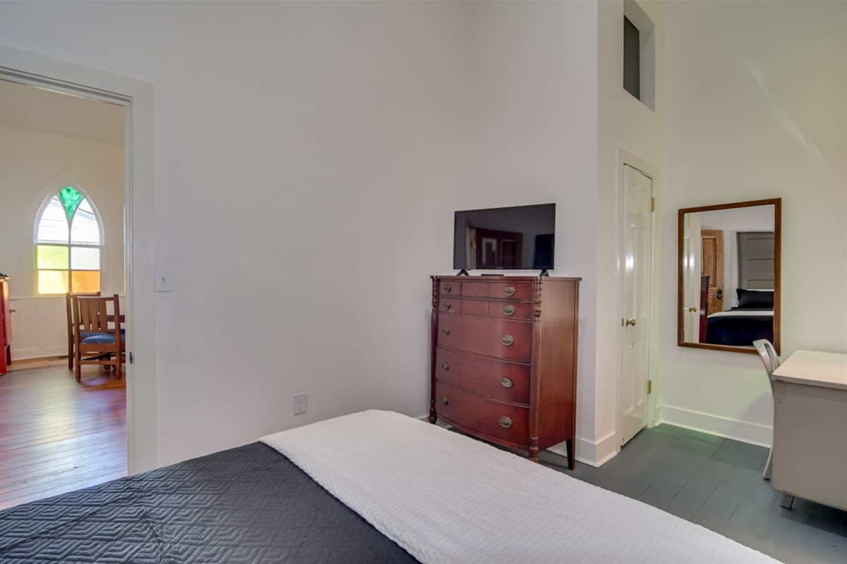 Guest bedroom with cozy queen bed and a TV
