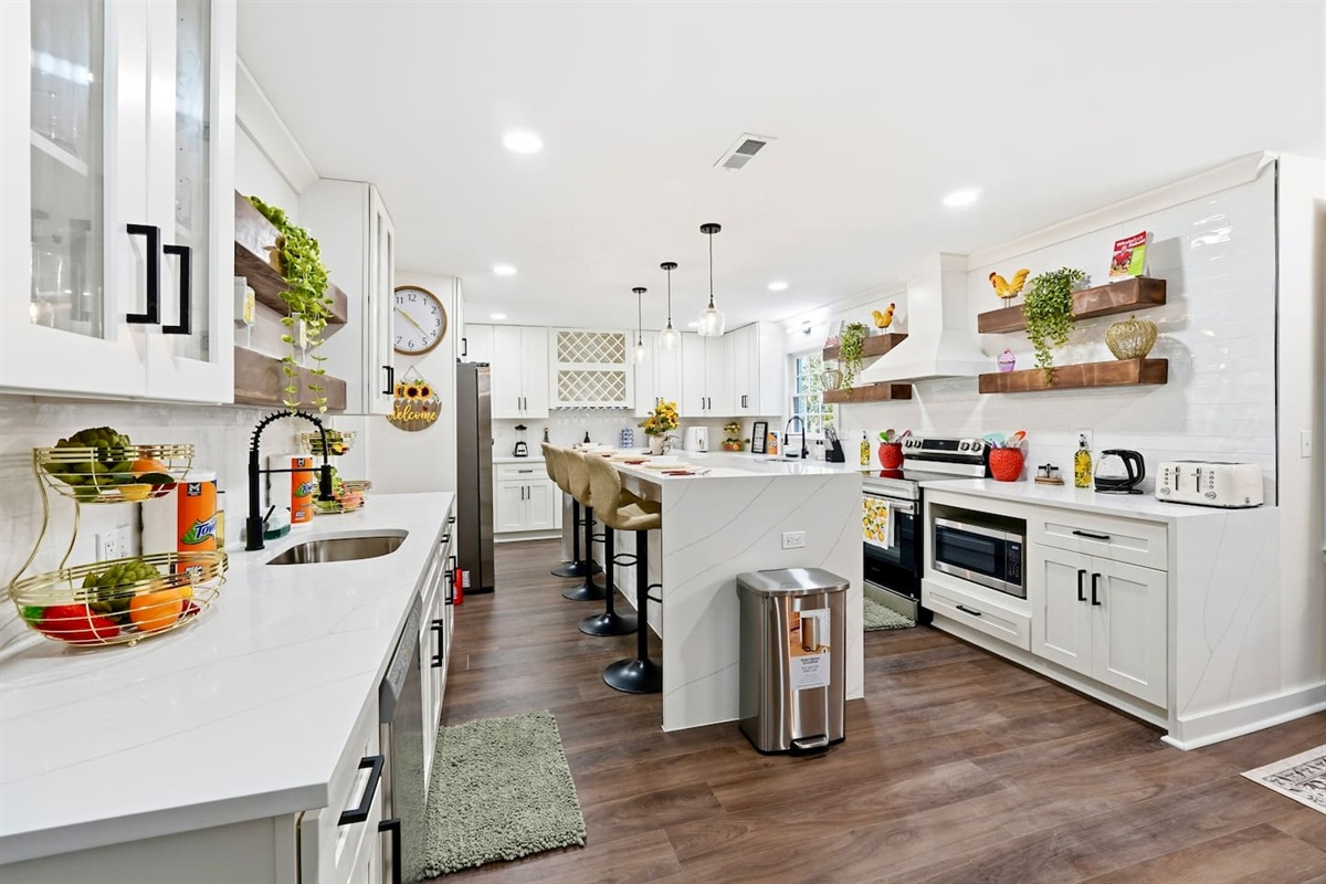Beautiful white kitchen fully equipped with all the appliances and essentials of a home away from home.