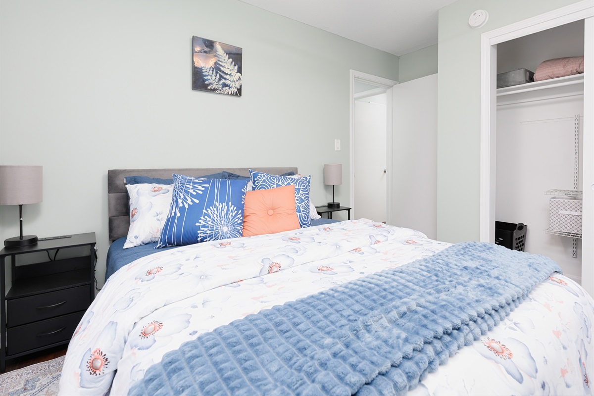 Comfortable guest bedroom with queen bed, soft natural light, and neutral décor.