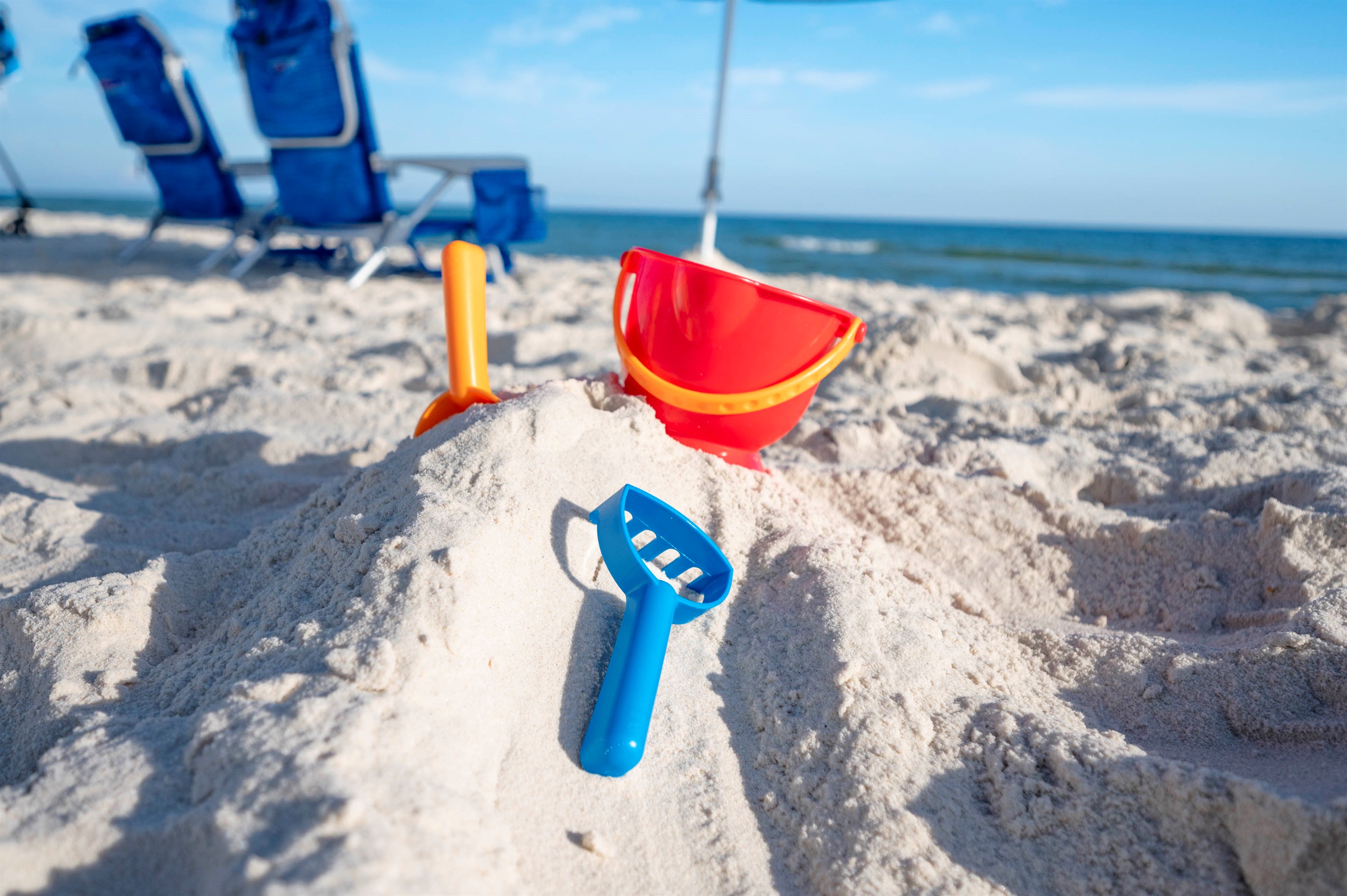 Beach vibes: Sandcastles, colorful toys, and sunny ocean fun for everyone!