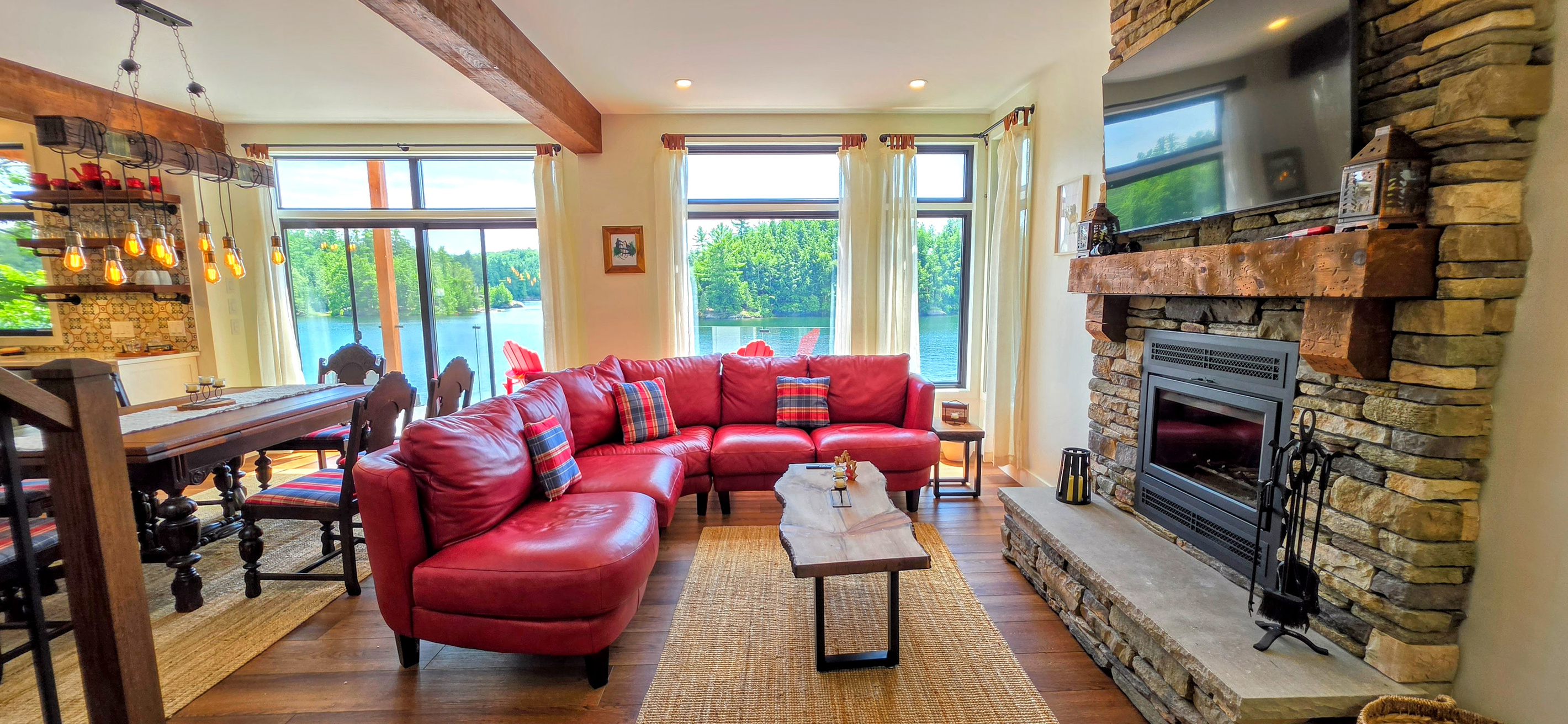 Living room seating with wood-burning fireplace and large TV