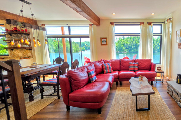 Living room seating with wood-burning fireplace and large TV