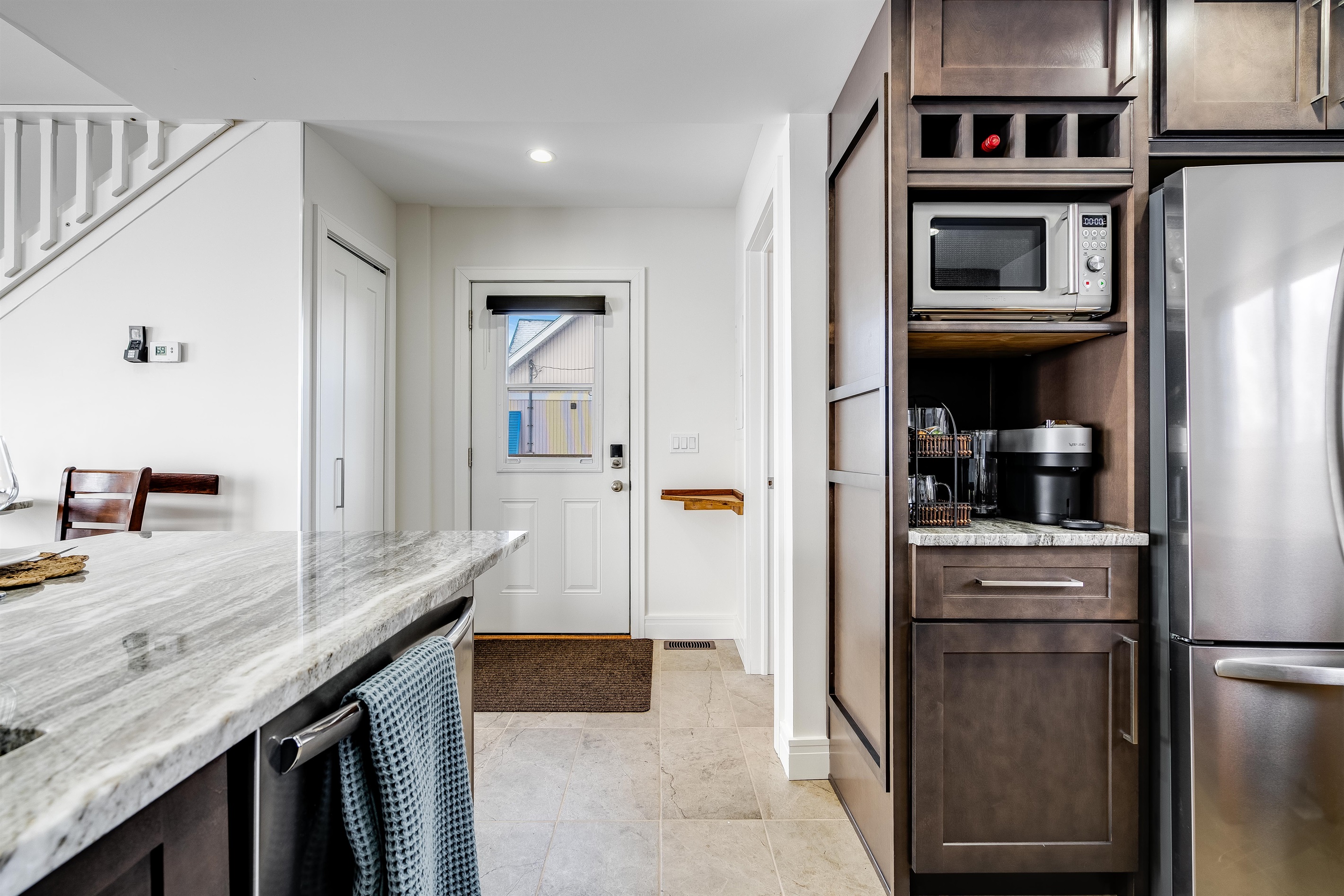 Streamlined cabinetry blends white and natural oak.