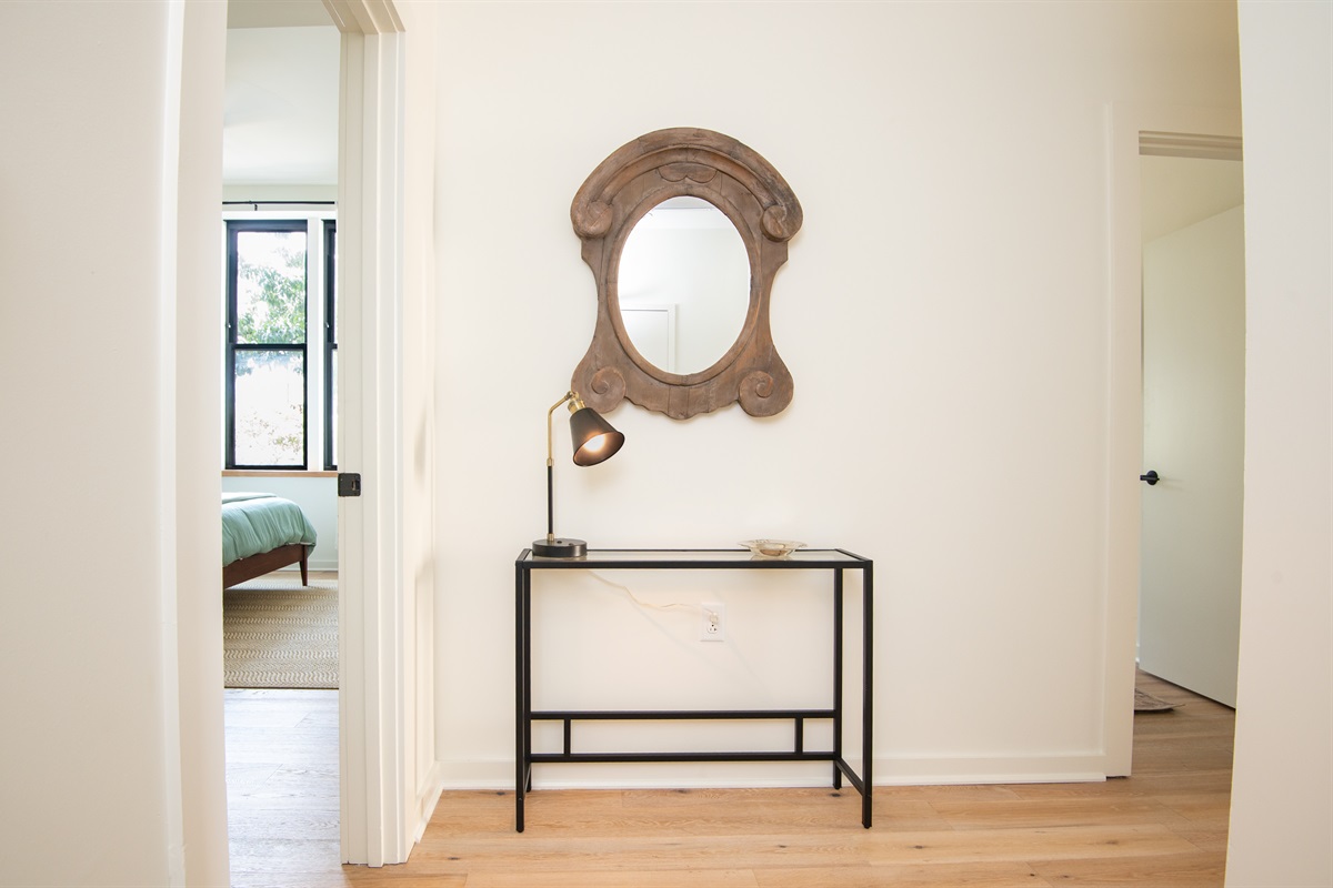 Hallway view with decorative mirror and console table accent