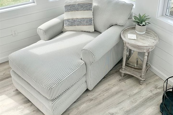 Stretch out and relax in this oversized striped chaise lounge. Tucked into a sunlit corner with a rustic side table, it’s the perfect spot for a peaceful afternoon nap or catching up on your favorite book.