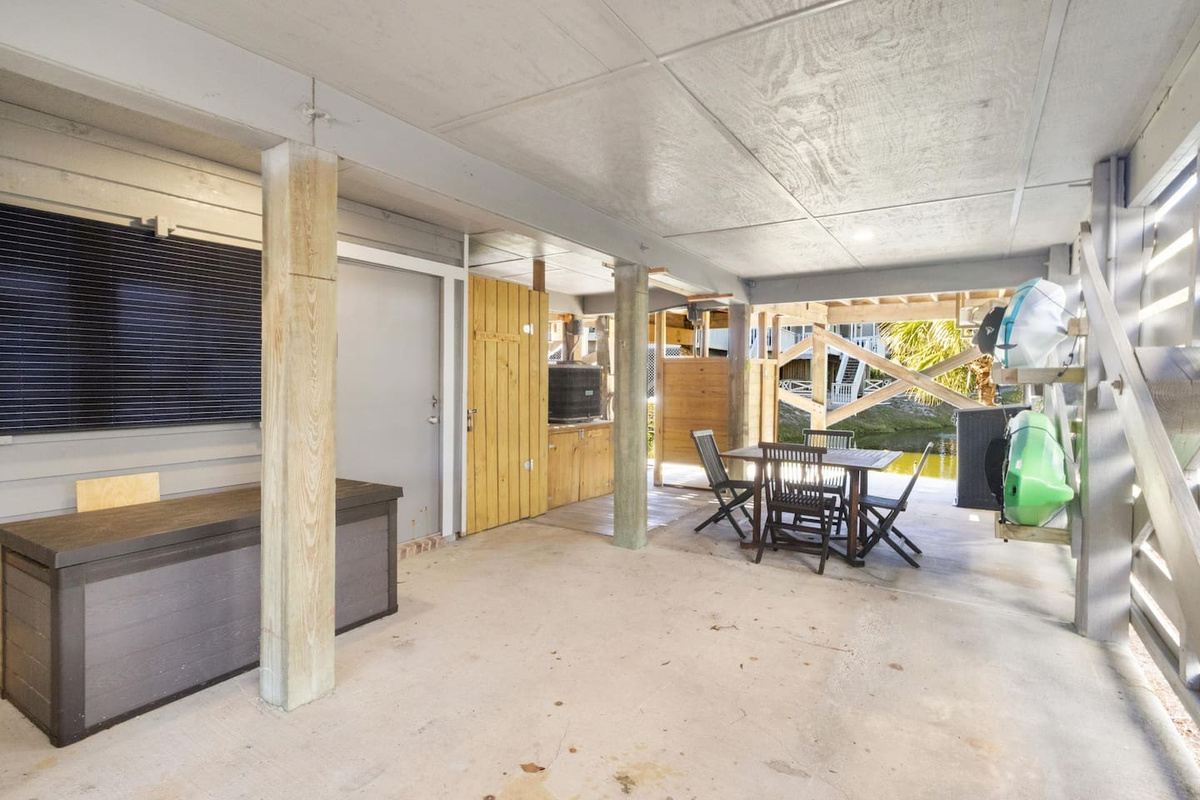 Your carport doubles as base camp: stocked beach closet, room to gear up, and a turtle pond to greet you every time.