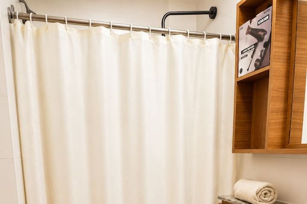 Bathroom 2, featuring a spacious shower area and stylish vanity storage.