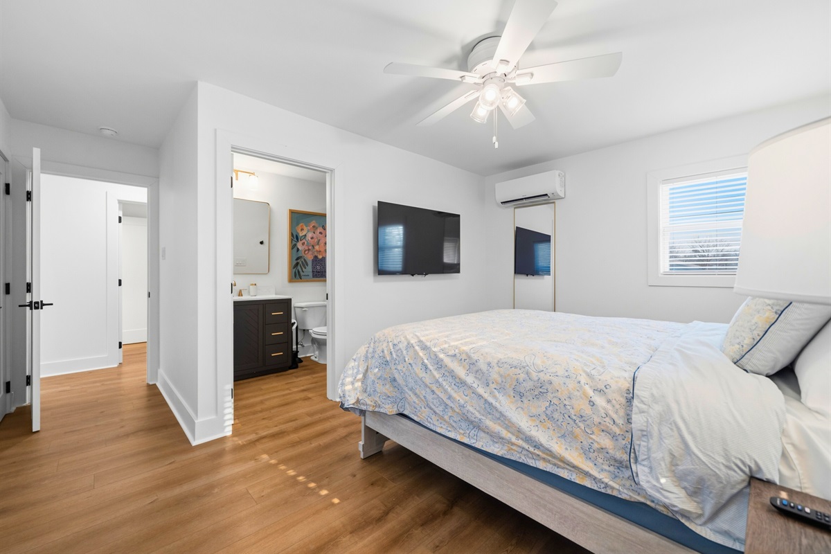 This relaxing bedroom offers a simple yet welcoming layout that provides plenty of room to rest comfortably.