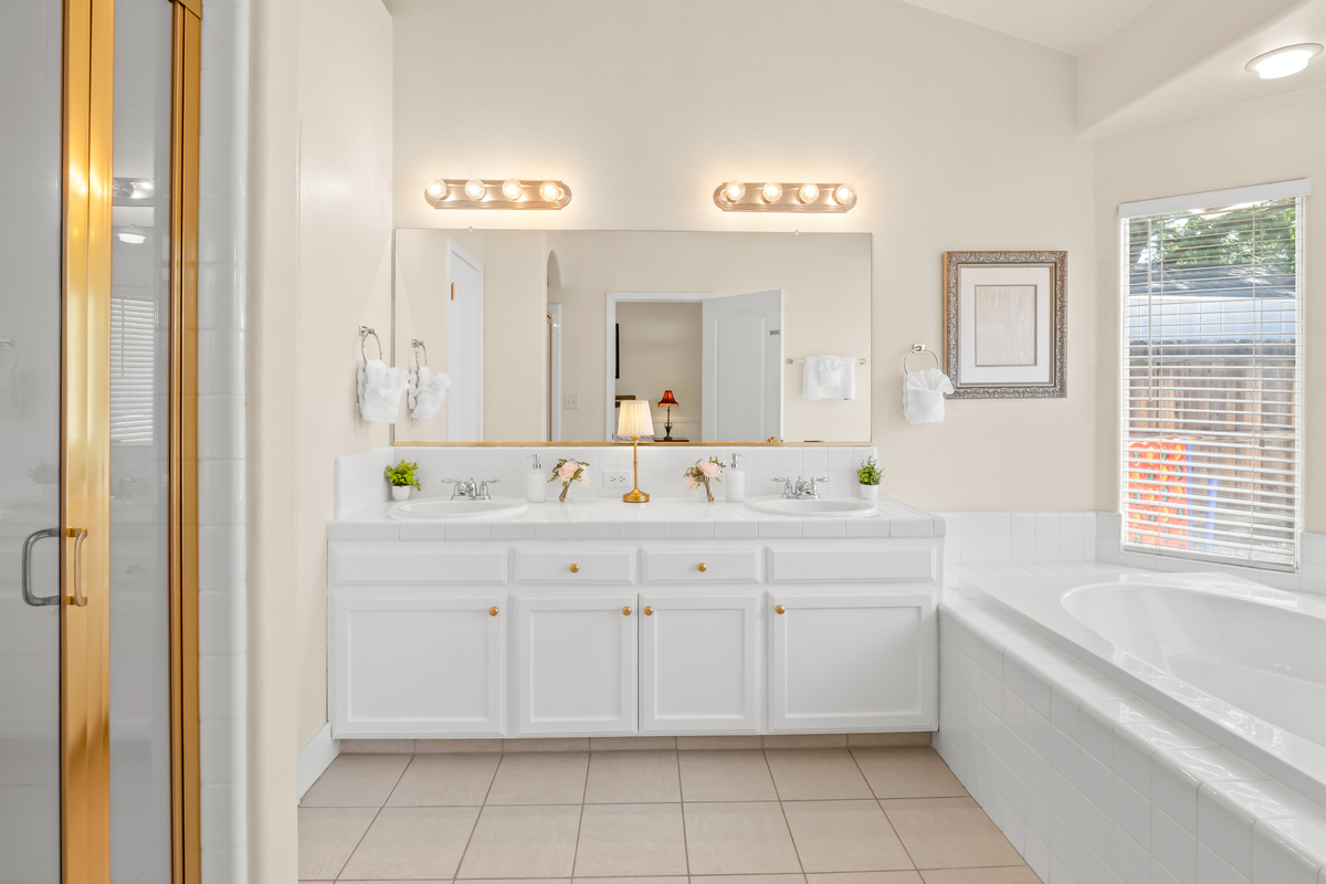 Treat yourself to a little extra comfort in this beautifully appointed primary bathroom. Featuring double sinks, a soaking tub, and separate shower, it's the perfect place to recharge after a day of adventure.