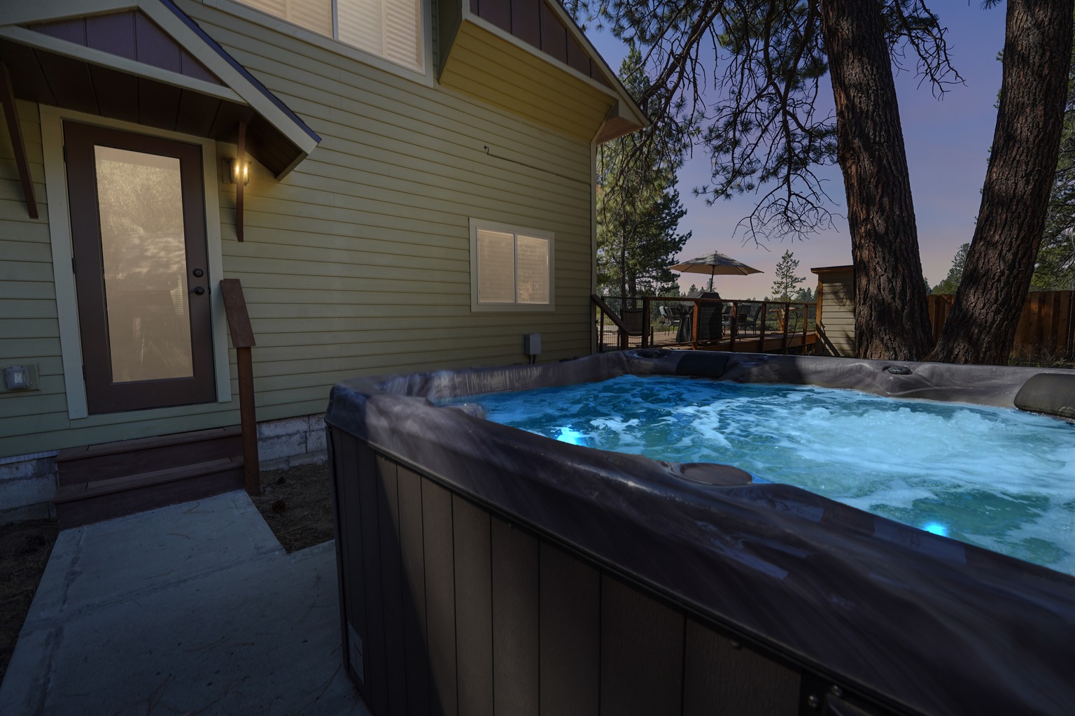 Private hot tub surrounded by pines and open skies