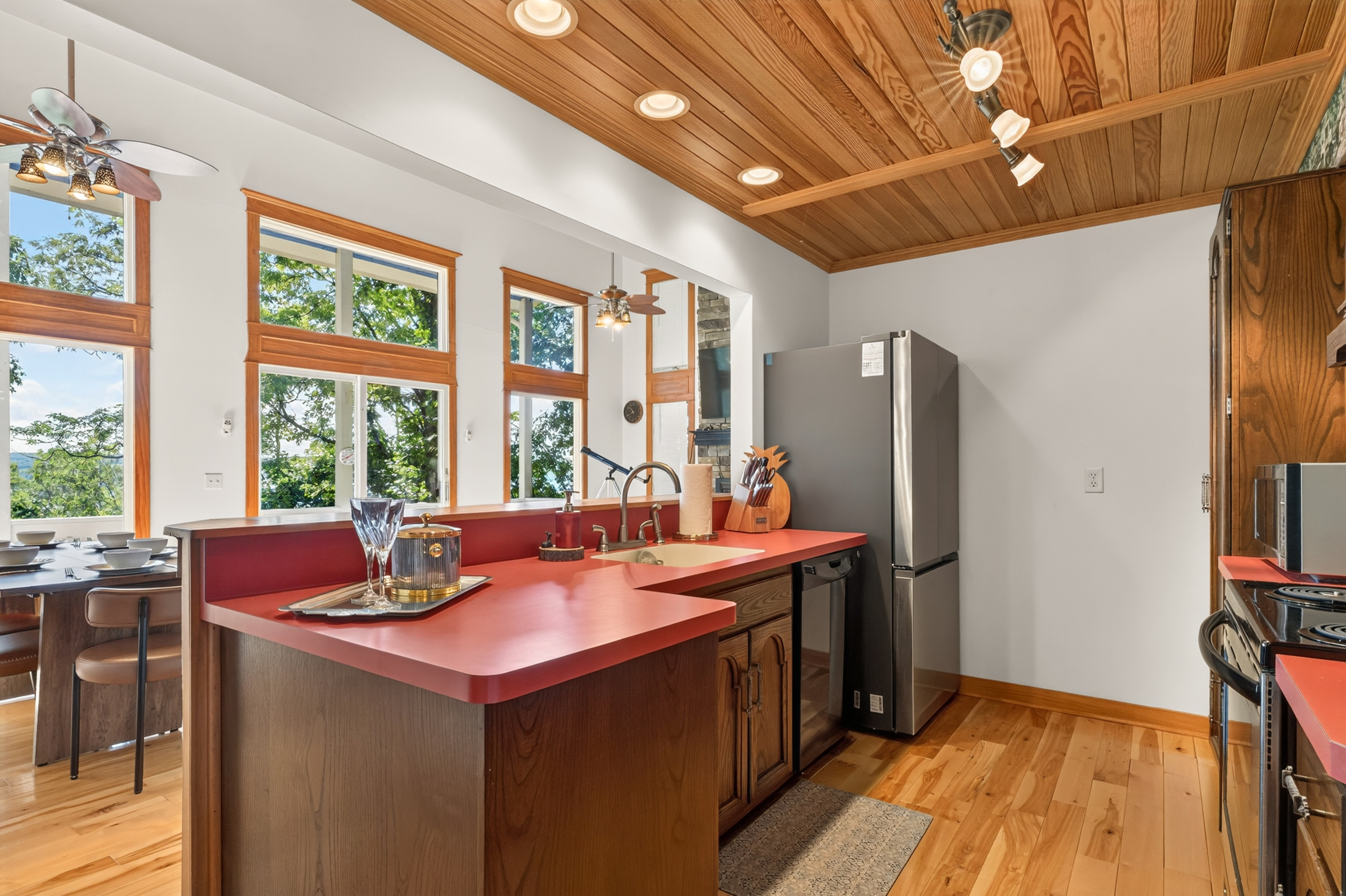 Kitchen island beside floor-to-ceiling windows