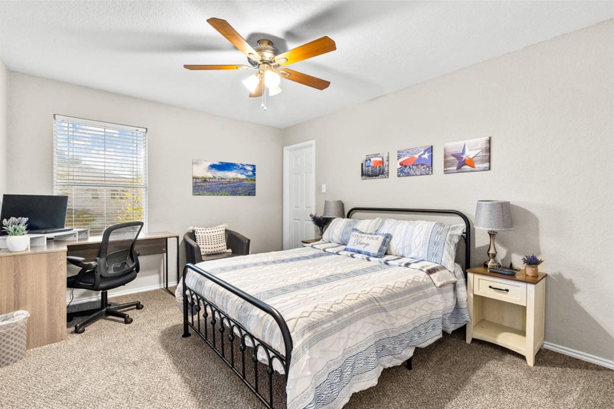 Queen bedroom retreat featuring a dedicated workspace with natural light and strong internet, plus room-darkening blinds, soft bedding, and ample closet storage for long or short stays.