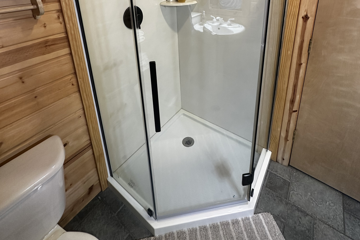 The renovated clear glass enclosed shower upstairs is beautiful.