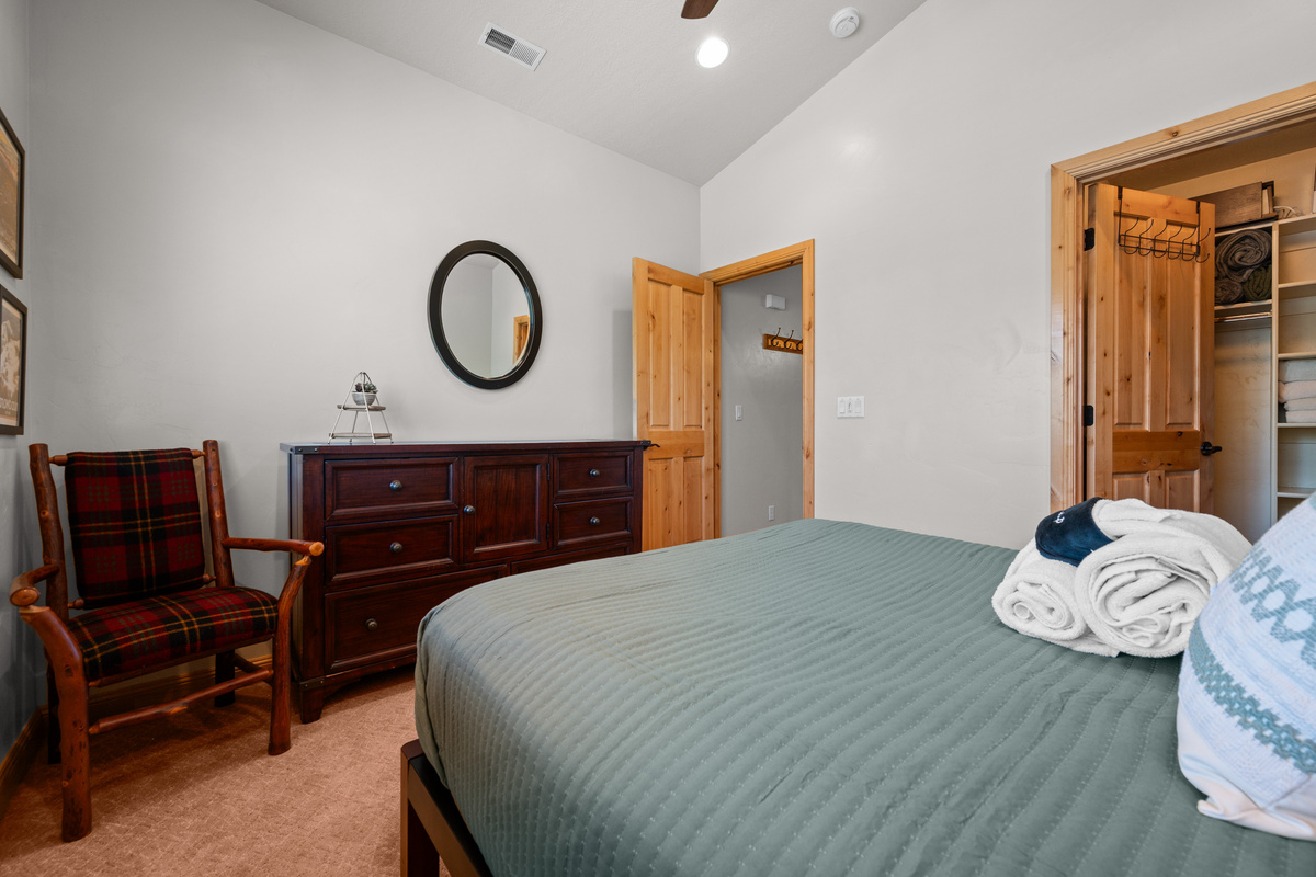 Main floor bedroom featuring comfortable furnishings and ample storage.