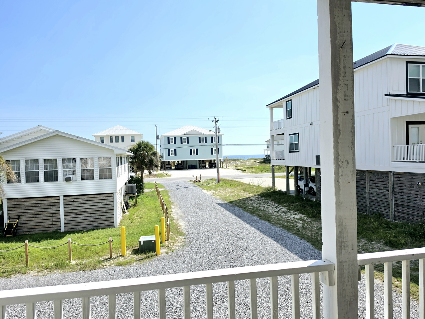 Nest side – Covered balcony view down the street toward the Gulf