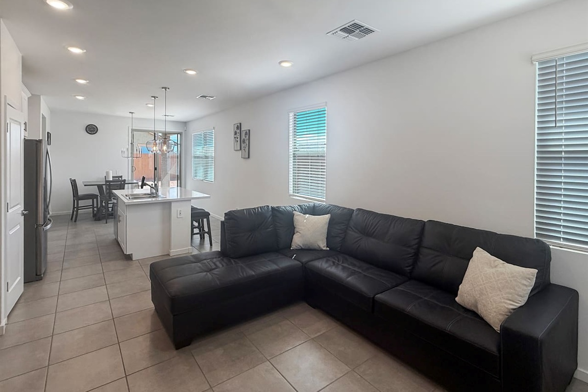 Living room with sectional sofa and window blinds