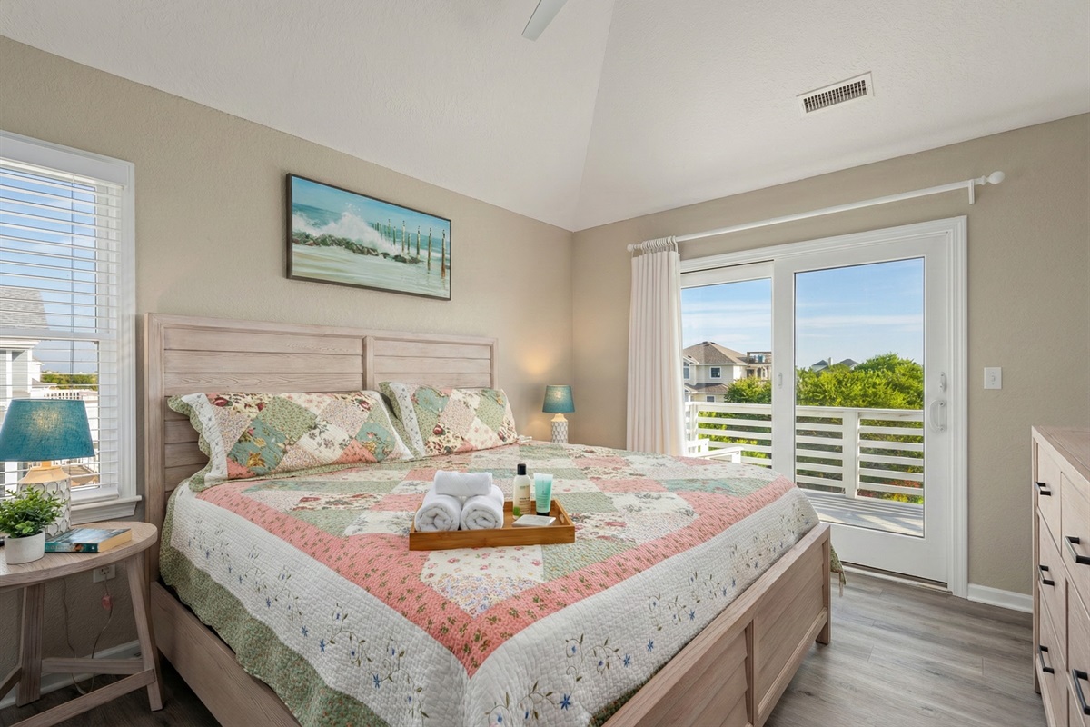 TL Bedroom 1 - Serene bedroom with cozy bedding and direct balcony access.