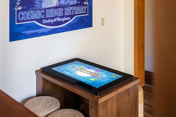 Just off the main living room, enjoy the Infinity Game Table—featuring hundreds of family favorites from checkers to trivia, all in one digital hub.
