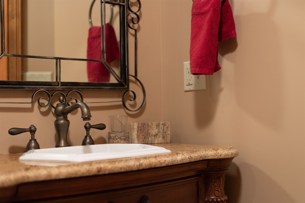 Rustic finishes and elegant details bring warmth and charm to the lower-level bathroom vanity area.