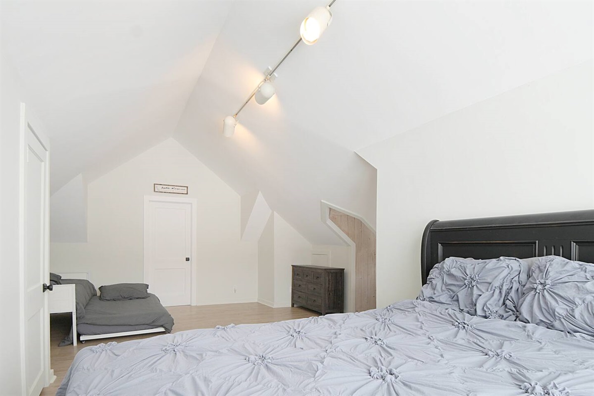 Main bedroom of the home boasts a cozy queen bed and a trundle that pulls out for 2 singles! 