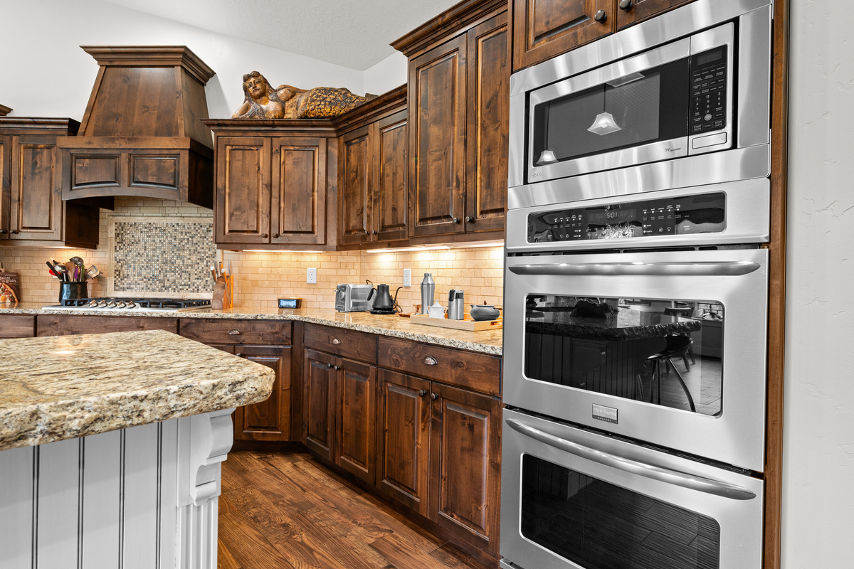 Well-Equipped Gourmet Kitchen – Double wall ovens, premium appliances, expansive granite countertops, and custom cabinetry provide everything you need to prepare meals for your entire group.