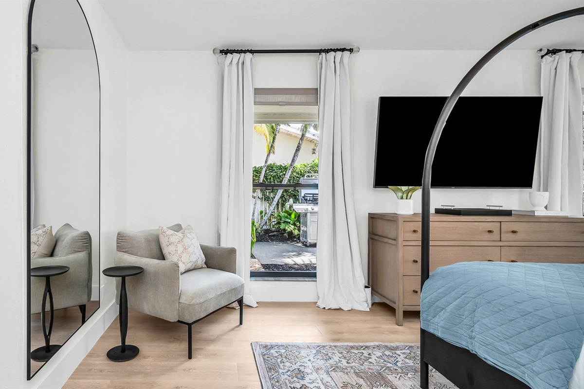 This second primary suite offers a plush king bed, private ensuite bathroom, and walk-in closet for added comfort. Enjoy poolside views and direct access to the outdoor living area, making it the perfect blend of luxury and convenience.