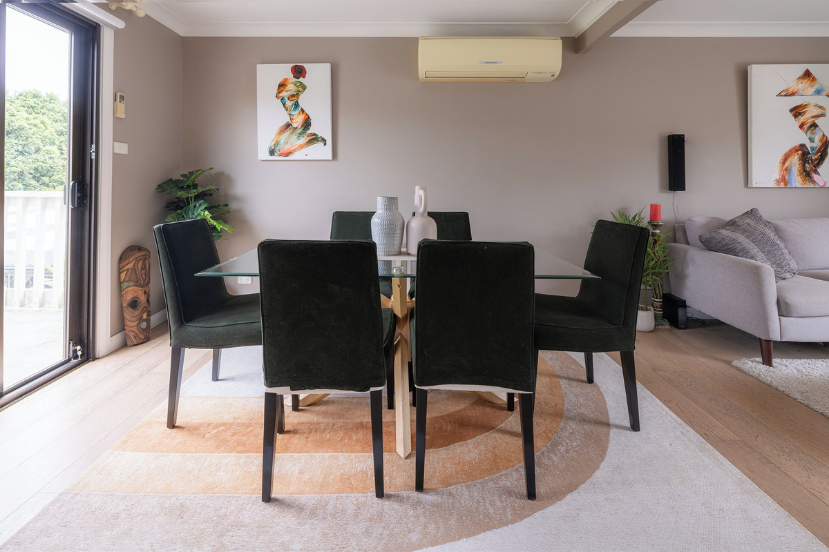 The dining space at Luna’s Sanctuary seats six and sits beside the balcony doors, with the main living area close by.