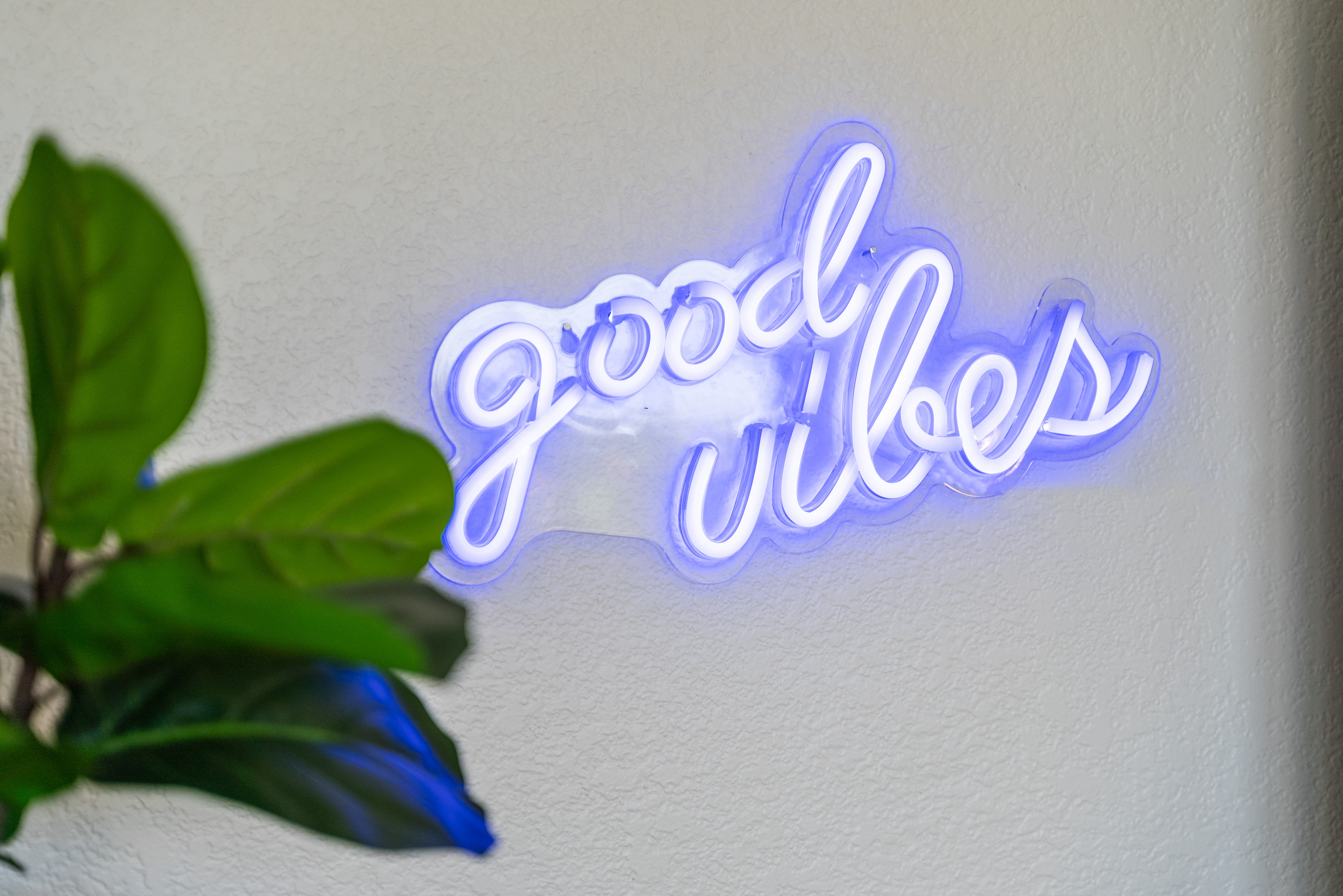 Good vibes only — a neon sign sets the fun, feel-good tone of this home.