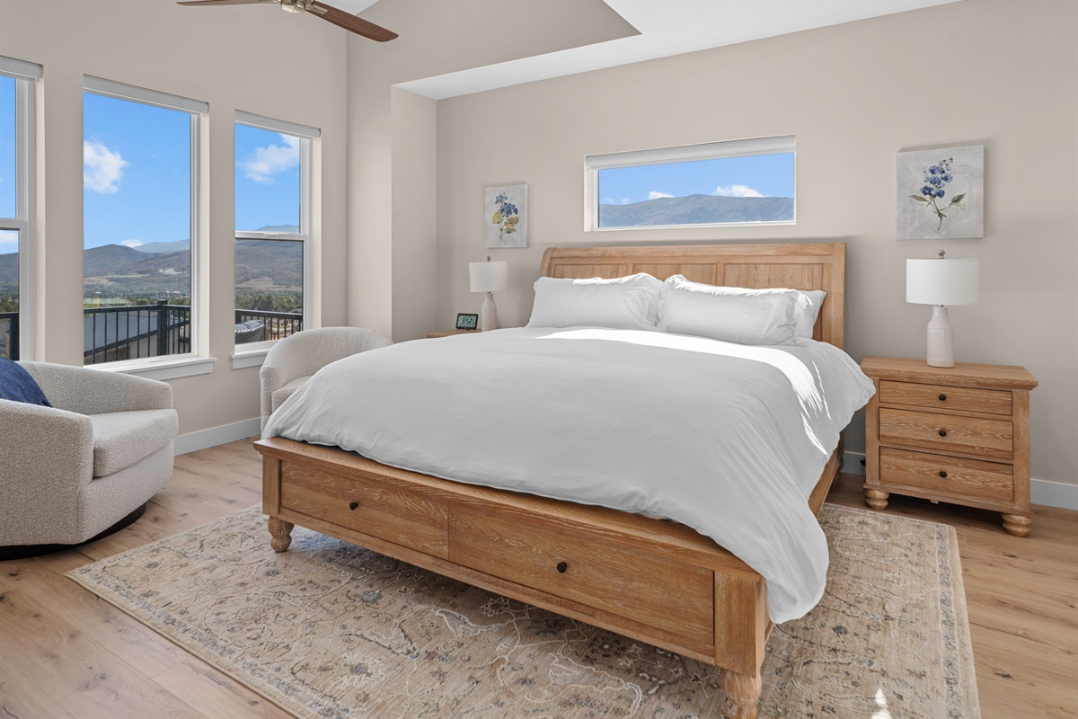 Primary suite with large windows and stunning mountain views.