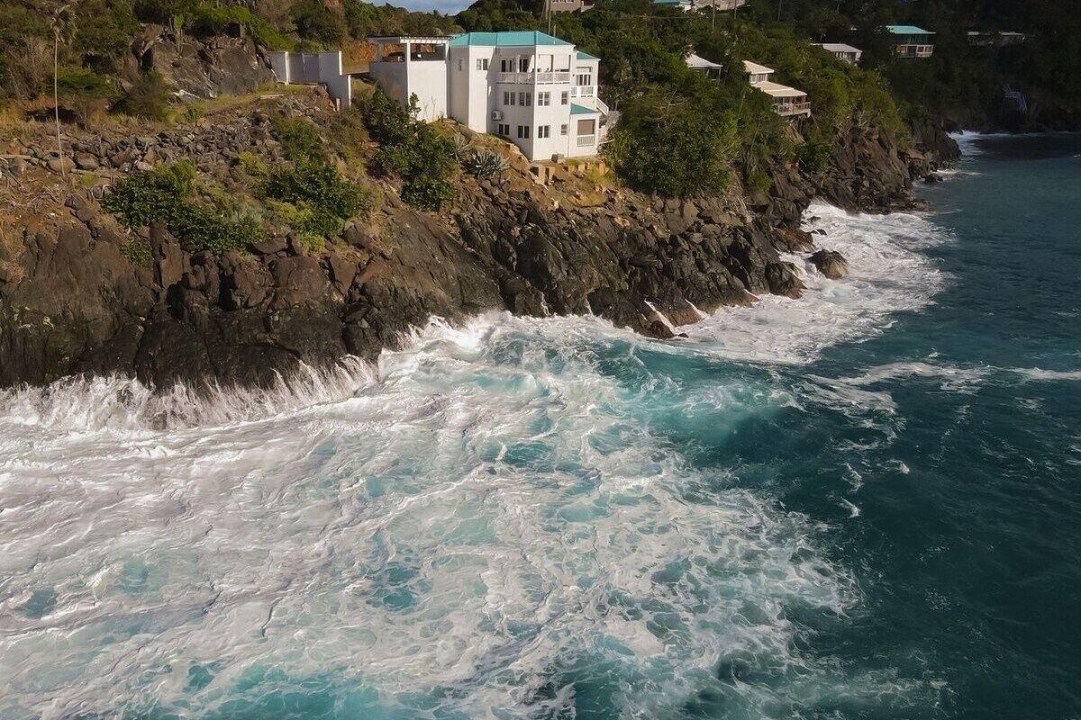 Waves crash just below the home.