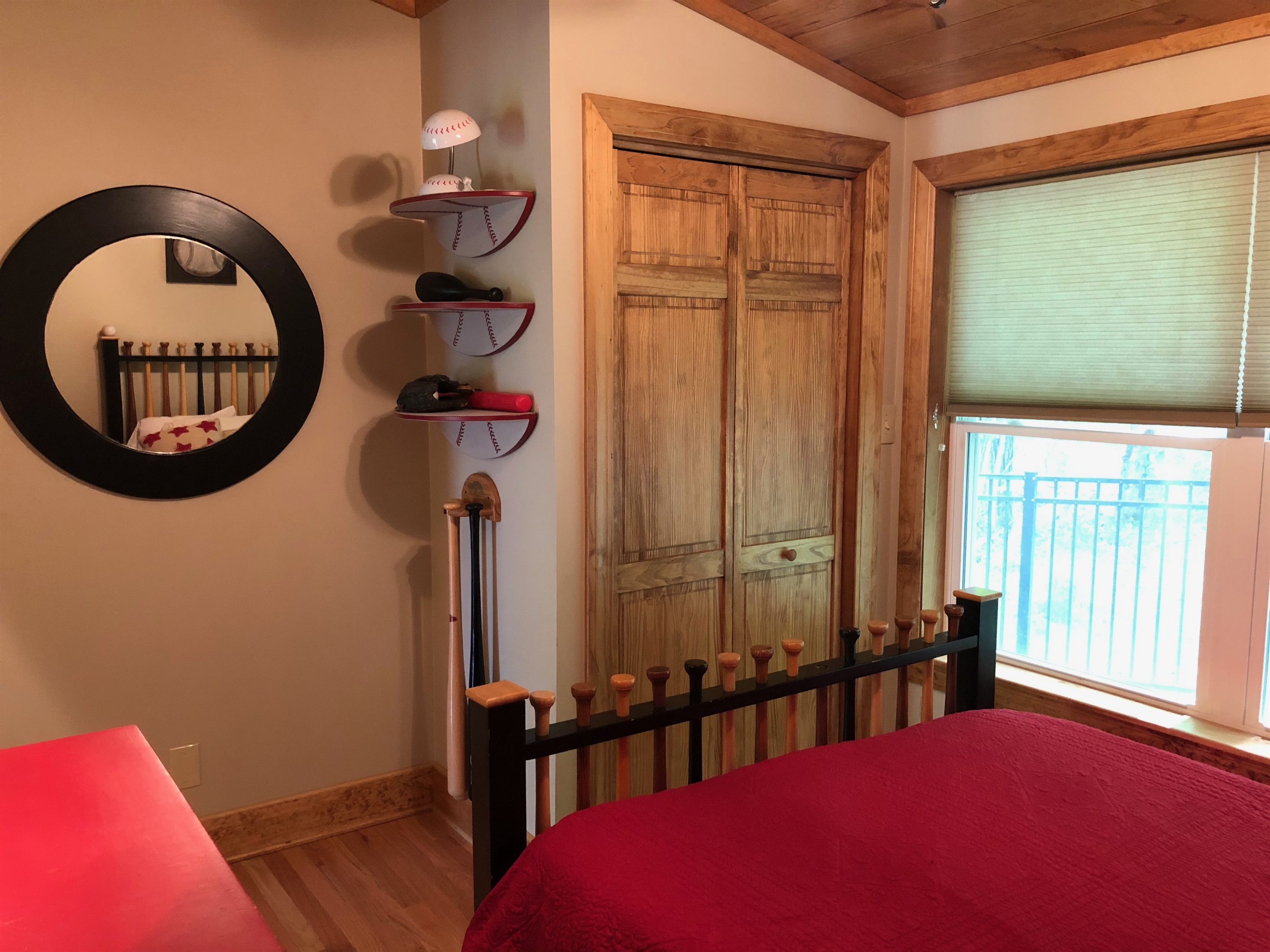 Queen bedroom with baseball décor.