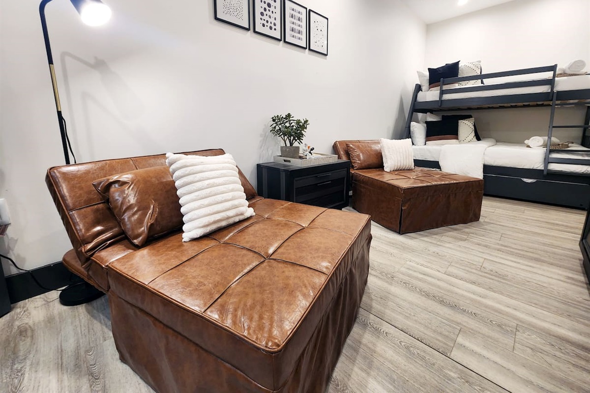 Bedroom with twin over full bunk and trundle with two sleeper chairs that make king or two twin beds