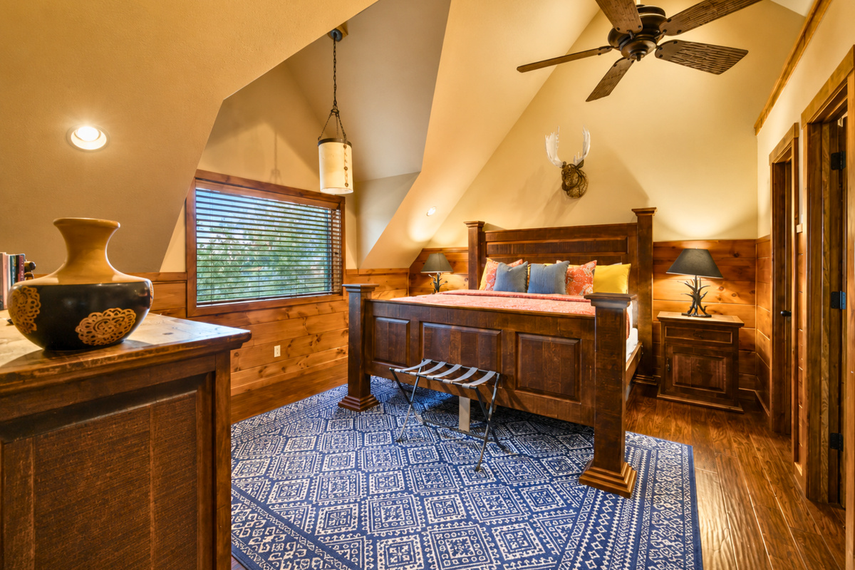 There is plenty of space to unpack and get comfortable here, with a roomy layout, additional seating, and warm details that make the room feel right at home in the cabin.