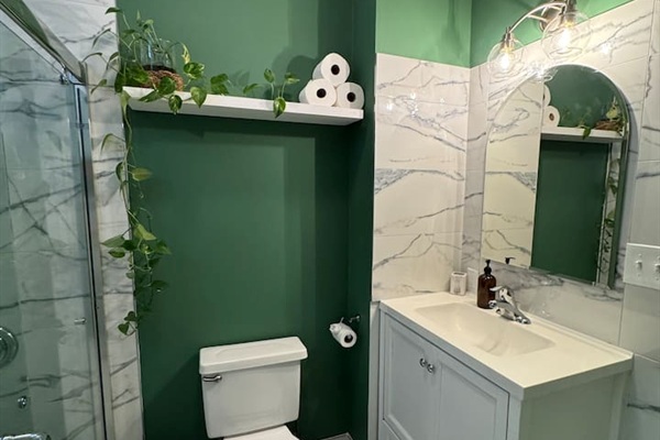 Modern bathroom with stylish green accents and clean finishes.