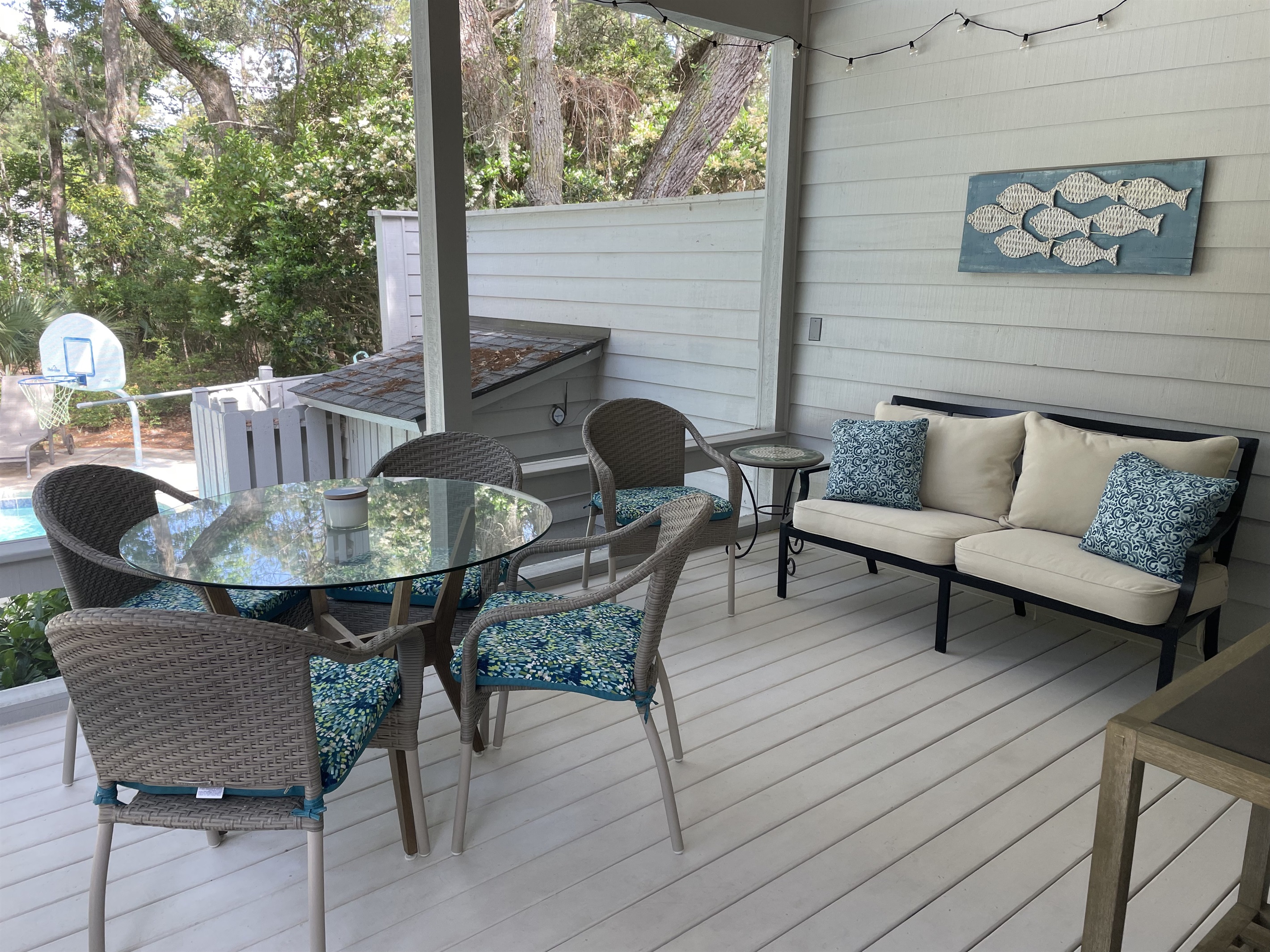 Screen porch, a great place for relaxing and watching the kids in the pool