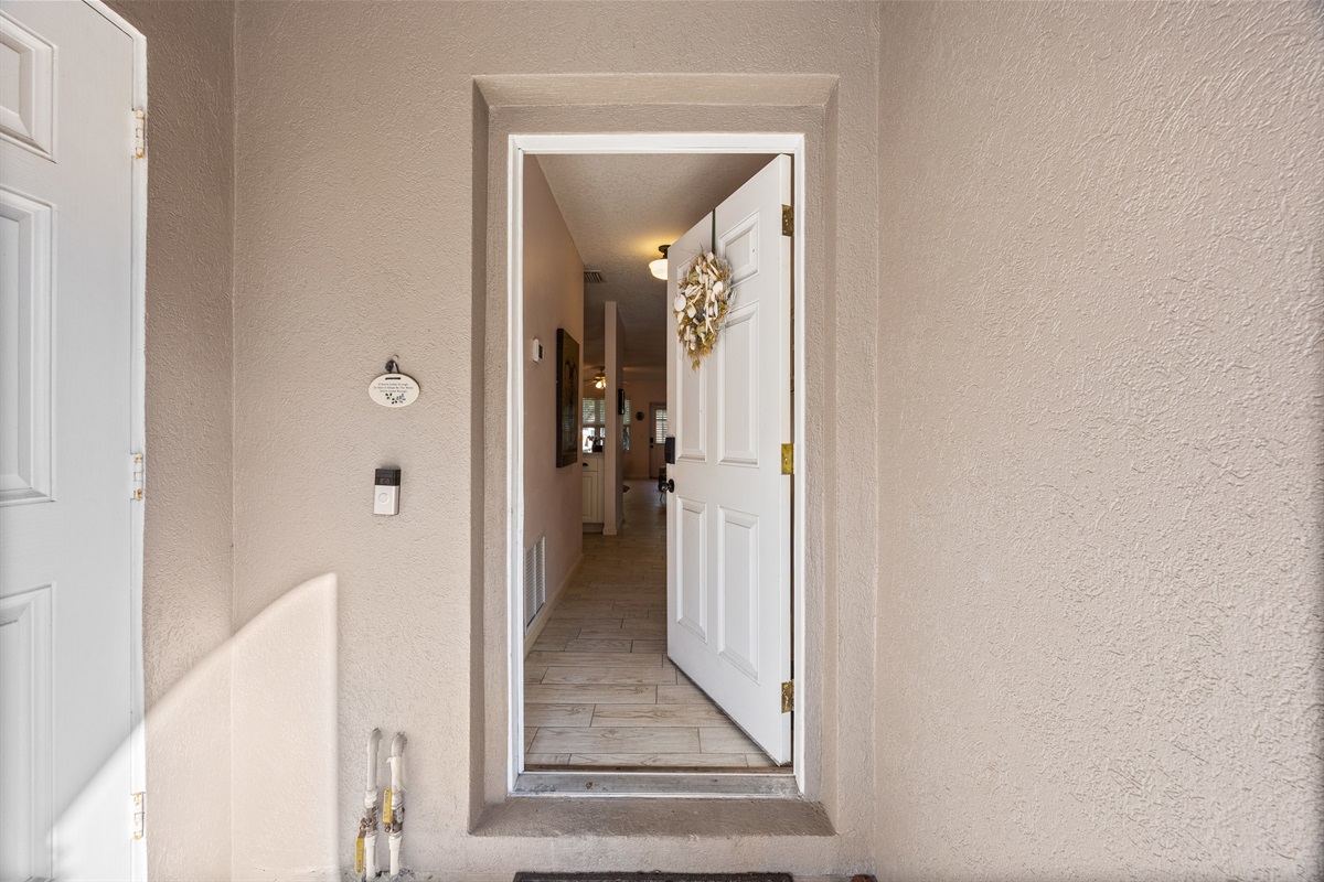 Welcoming front entrance with bright natural light and charming décor to greet you as you arrive.