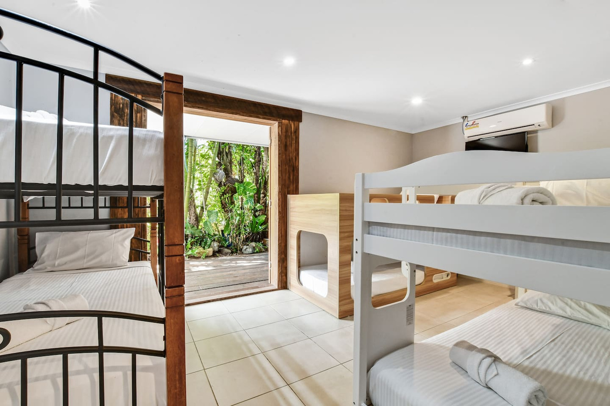 Three bunk beds make Bedroom 6 at Aaron's Beachside Boat House one of the home’s key group-sleeping rooms, with multiple separate sleeping spaces in one layout.